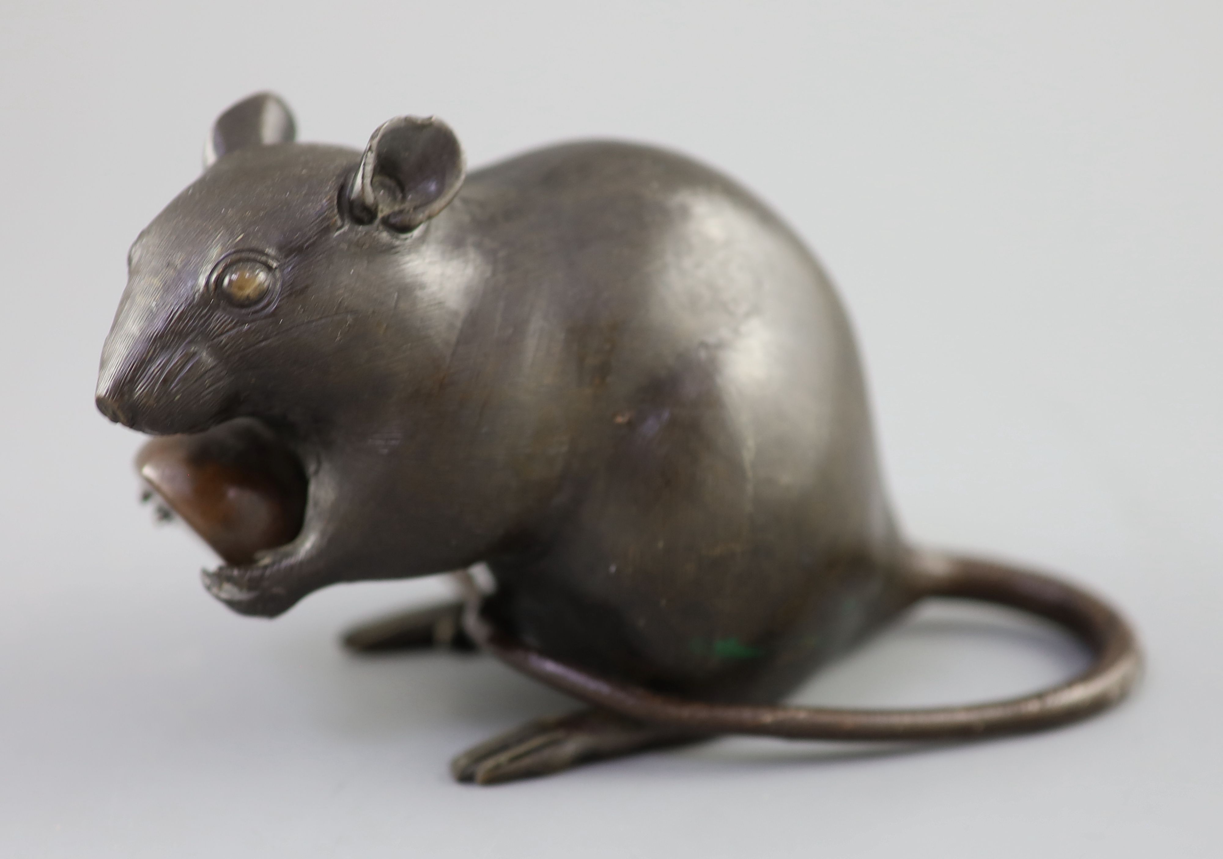 A Japanese bronze model of a rat holding a chestnut, Meiji period, 17cm long